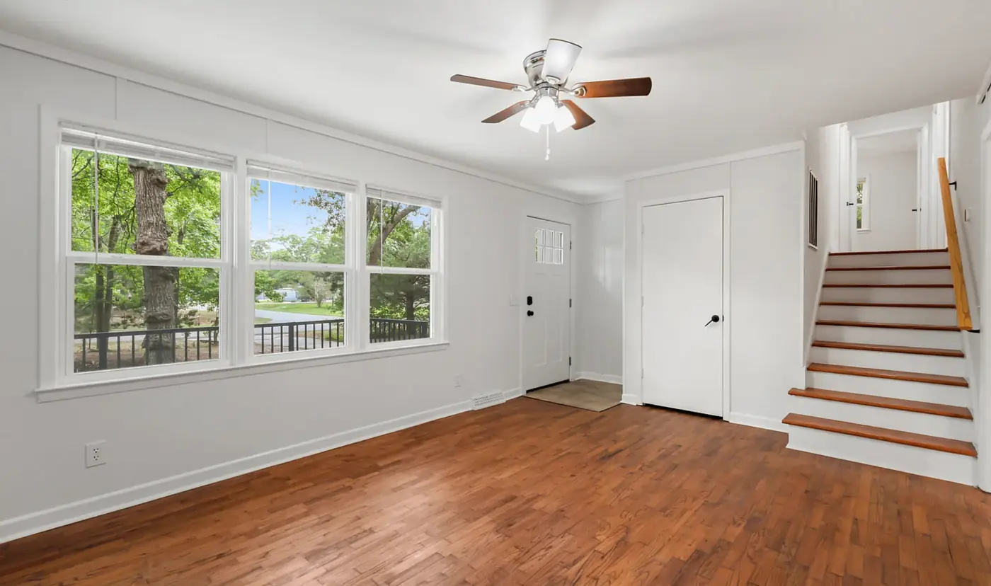 Bright living area with hardwood floors and large windows