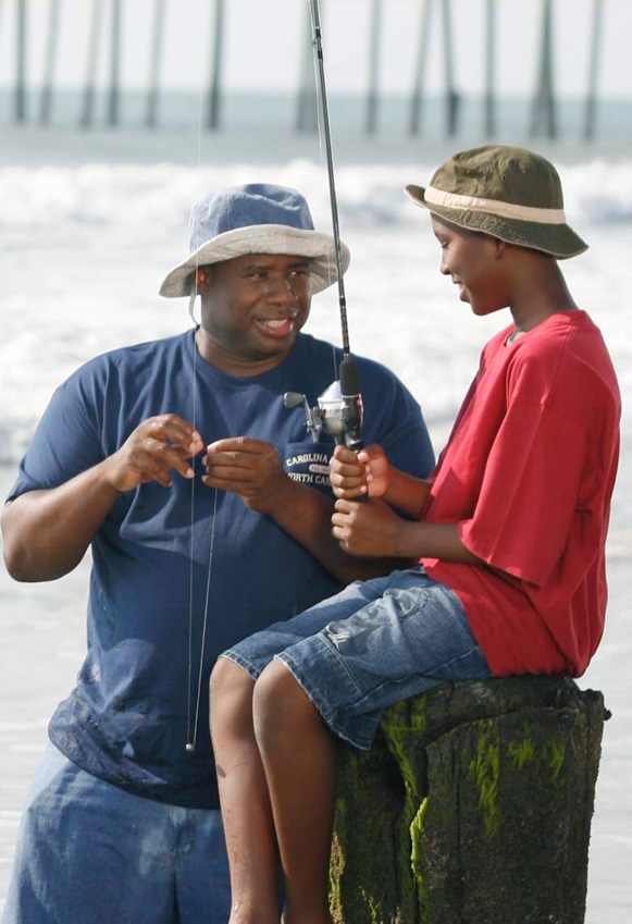 Father and son fishing from a Wrightsville Beach pier