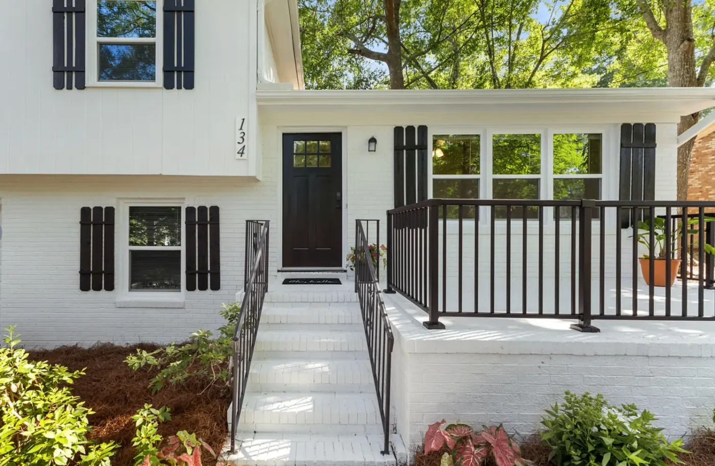 Front entry porch with black railings and coastal styling